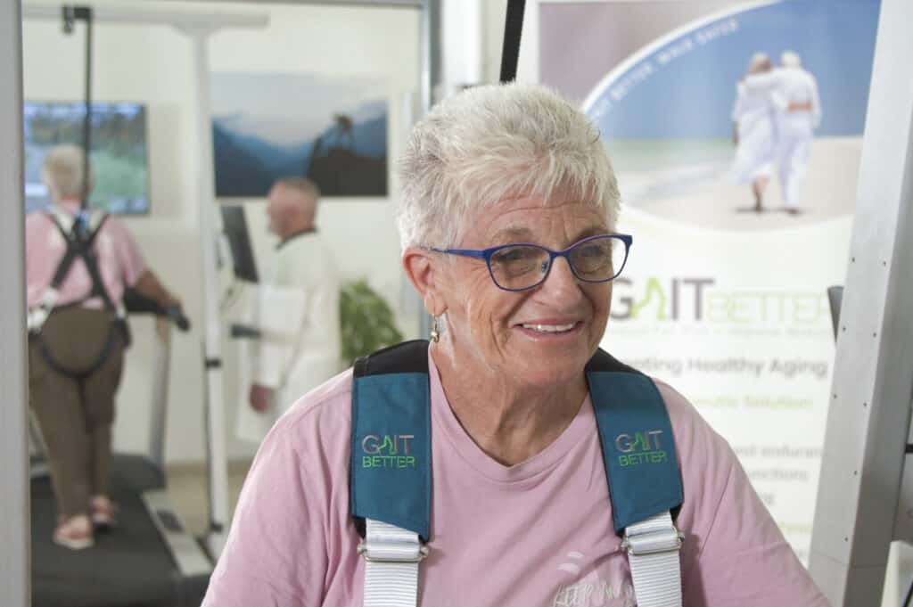 An elderly patient is happy after walking on the VR treadmill using GaitBetter's virtual reality motor-cognitive intervention for gait rehabilitation and fall prevention