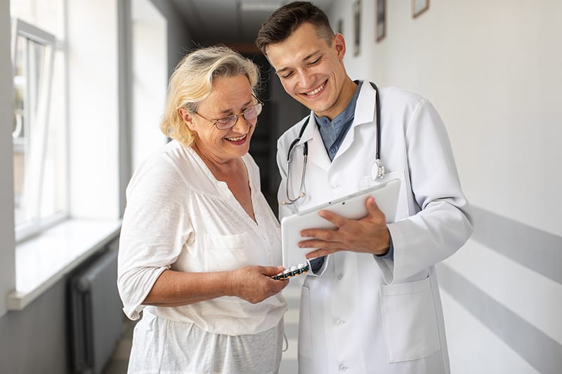 Physical therapist reviews elderly woman's rehabilitation process after a hip replacement